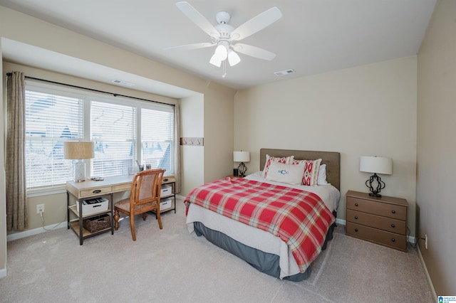 carpeted bedroom featuring baseboards, visible vents, and ceiling fan