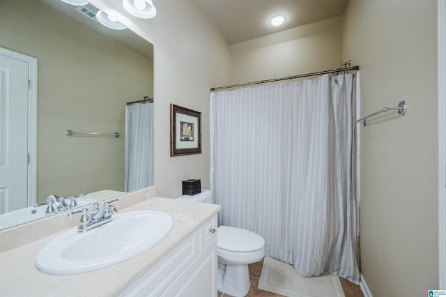 full bath featuring toilet, vanity, visible vents, and tile patterned floors