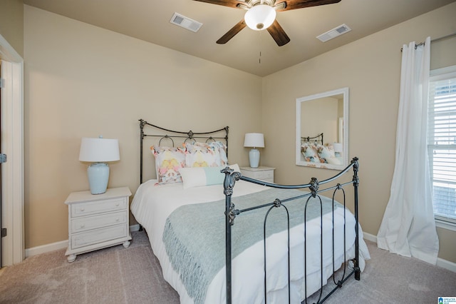 bedroom featuring ceiling fan, carpet flooring, visible vents, and baseboards