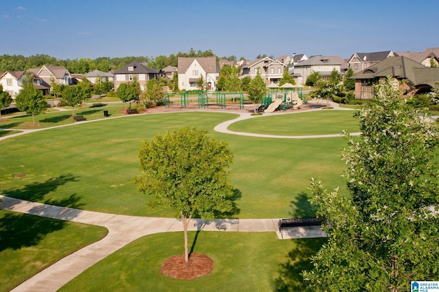 view of property's community with a residential view, playground community, and a yard