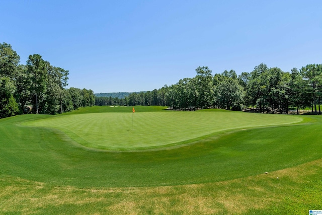 view of home's community featuring a yard and golf course view