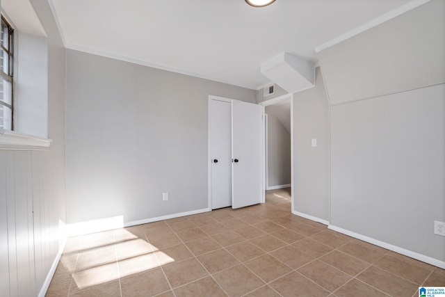 unfurnished bedroom featuring baseboards, visible vents, and tile patterned floors