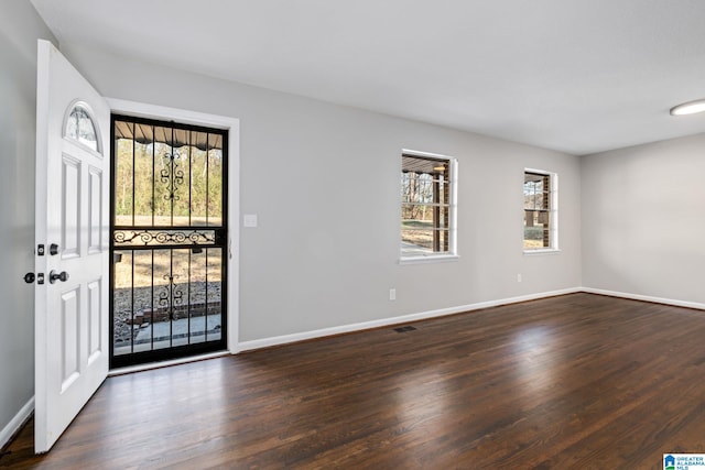 entryway with visible vents, baseboards, and wood finished floors