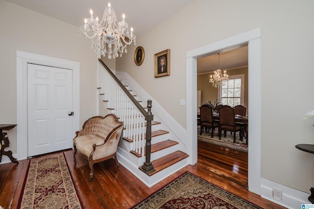 interior space featuring an inviting chandelier, baseboards, and wood finished floors