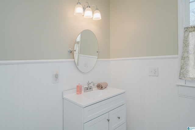 bathroom with a wainscoted wall and vanity