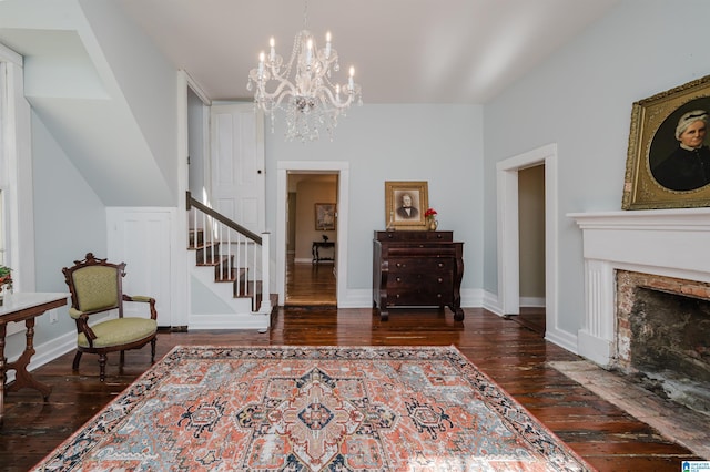 foyer entrance featuring stairway, a premium fireplace, wood-type flooring, and baseboards