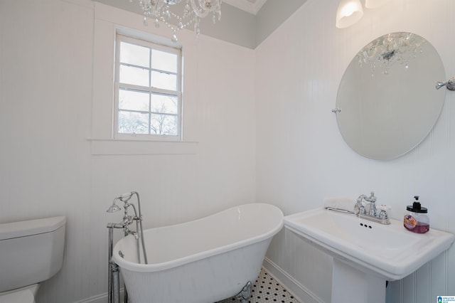 full bath with a soaking tub, a sink, and toilet