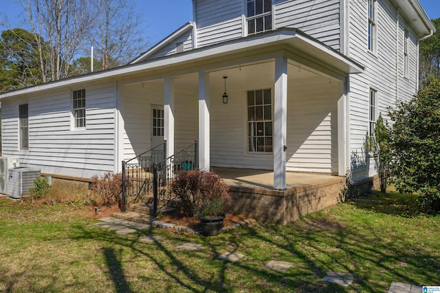 exterior space featuring a lawn and central air condition unit