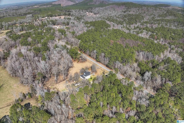 drone / aerial view featuring a wooded view