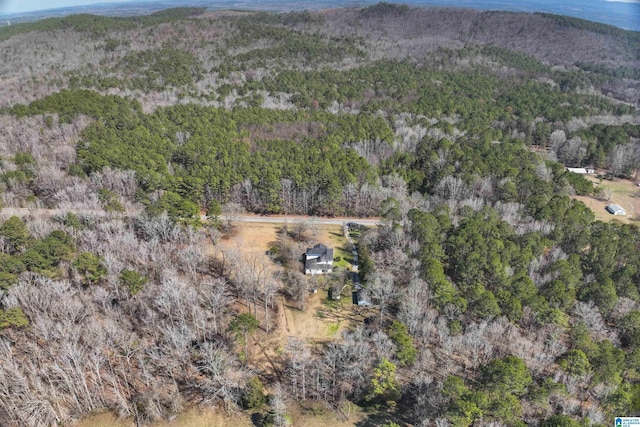 birds eye view of property featuring a view of trees