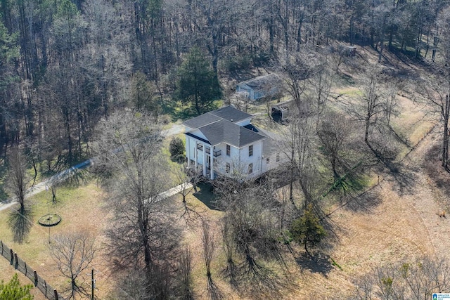 bird's eye view with a wooded view