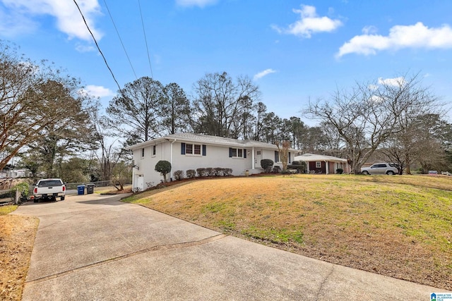 single story home with stucco siding, concrete driveway, and a front yard