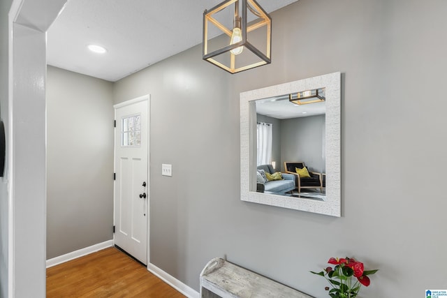 entrance foyer with recessed lighting, wood finished floors, and baseboards