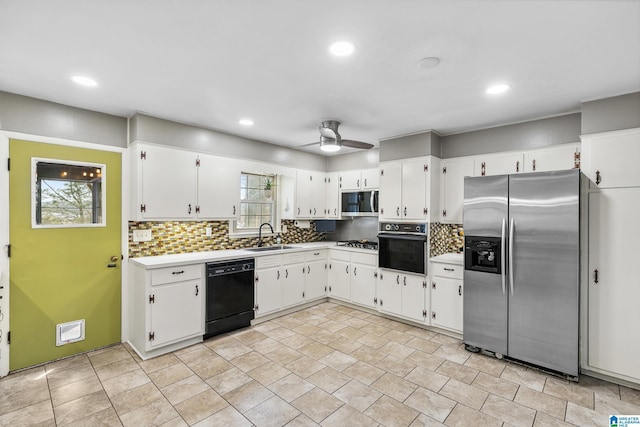 kitchen with decorative backsplash, light countertops, white cabinetry, and black appliances