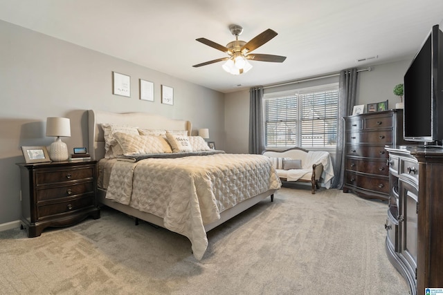 bedroom featuring ceiling fan, baseboards, and light colored carpet