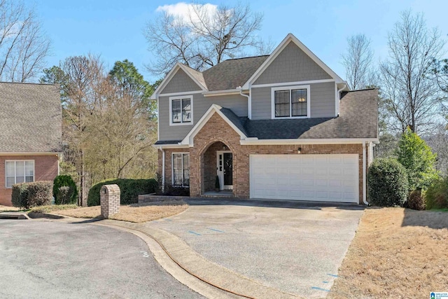 view of front of property featuring a garage, driveway, brick siding, and roof with shingles