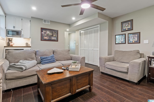 living room with ceiling fan, visible vents, dark wood finished floors, and recessed lighting