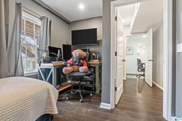 bedroom featuring dark wood-style floors and baseboards