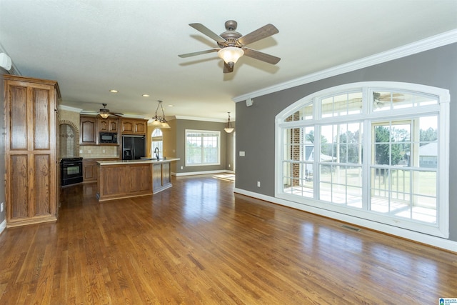 kitchen with visible vents, dark wood finished floors, open floor plan, light countertops, and black appliances