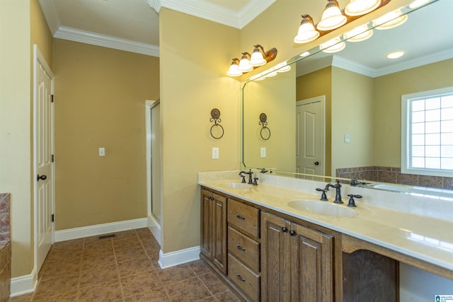 bathroom with double vanity, crown molding, baseboards, and a sink