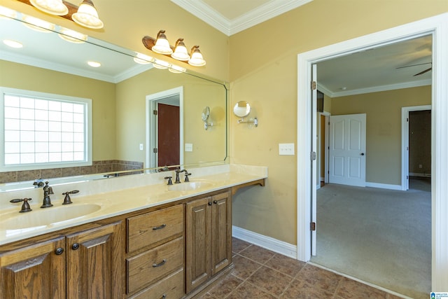 bathroom featuring a sink, baseboards, and crown molding