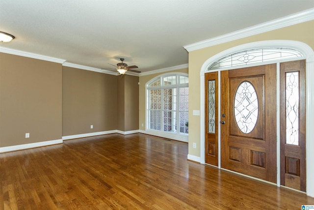 entrance foyer featuring a ceiling fan, crown molding, wood finished floors, and baseboards