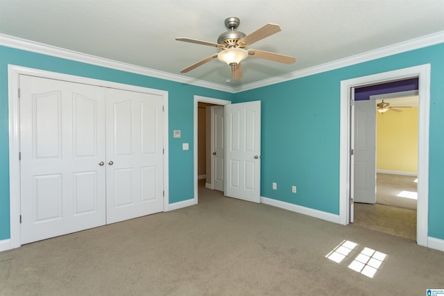 unfurnished bedroom with a closet, crown molding, and carpet floors