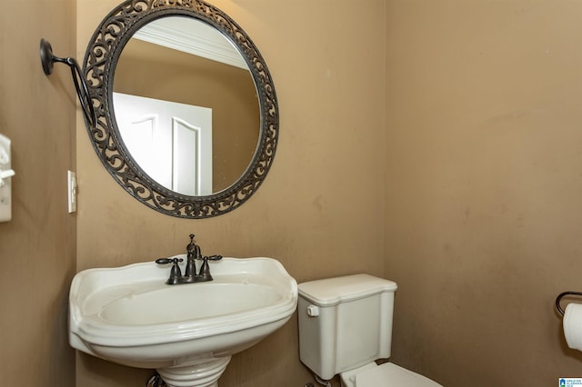 bathroom with toilet and a sink