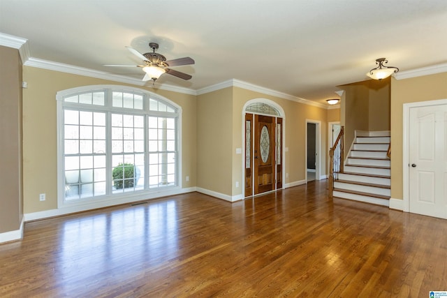 interior space featuring stairway, baseboards, wood finished floors, and ornamental molding