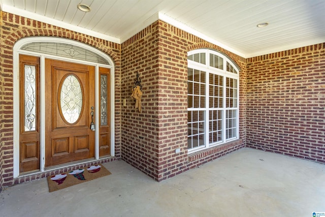 entrance to property with brick siding and covered porch