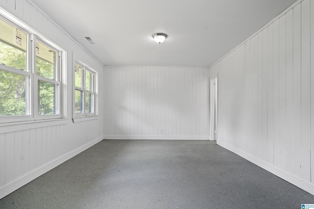 empty room featuring baseboards and visible vents