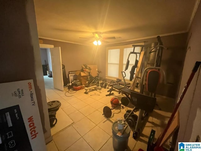 exercise area with tile patterned floors, a ceiling fan, and crown molding