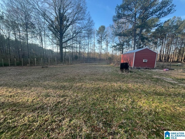 view of yard with an outdoor structure and fence