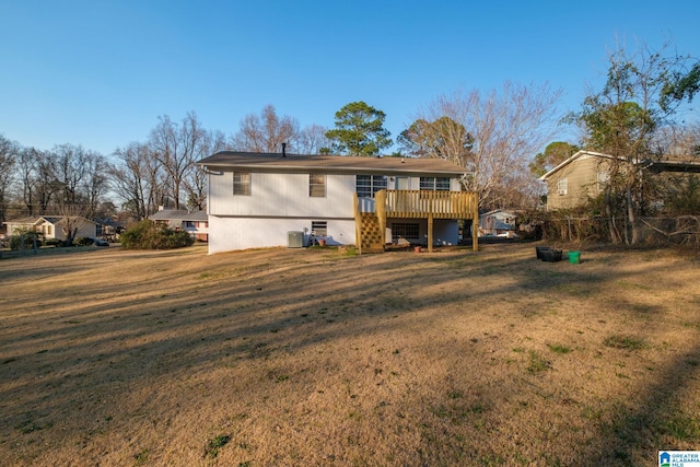 back of property with a lawn and a wooden deck