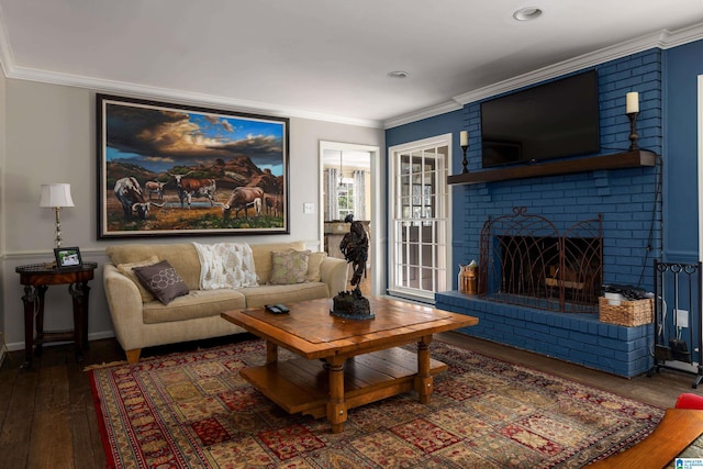 living area with ornamental molding, a fireplace, and hardwood / wood-style flooring