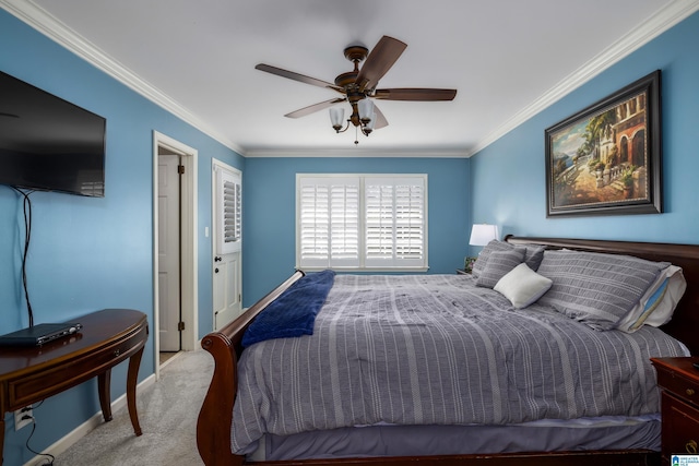 carpeted bedroom with baseboards, a ceiling fan, and crown molding