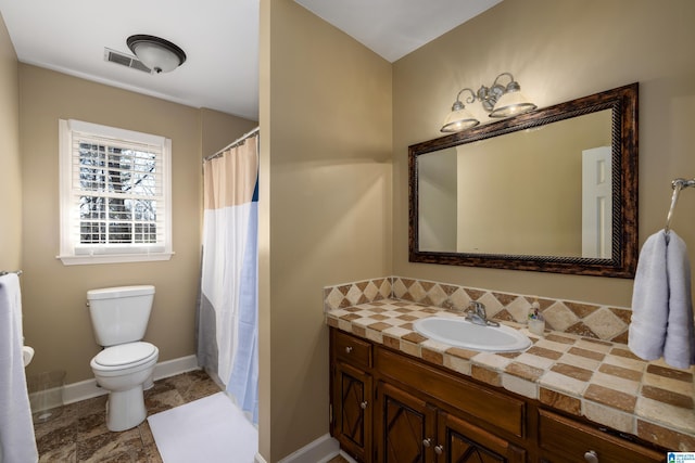 bathroom featuring visible vents, vanity, toilet, and baseboards