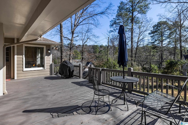 wooden terrace featuring a grill