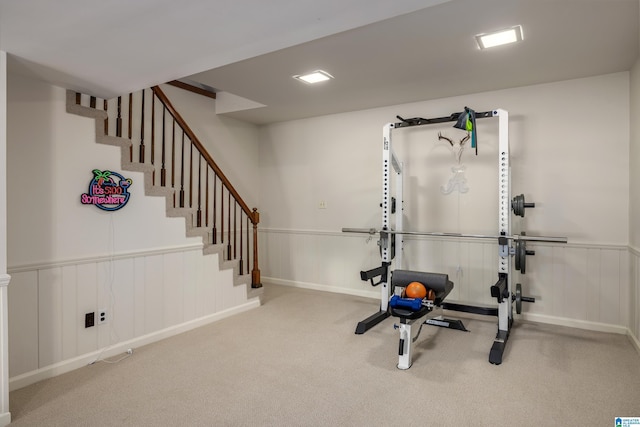 workout area with carpet floors and wainscoting