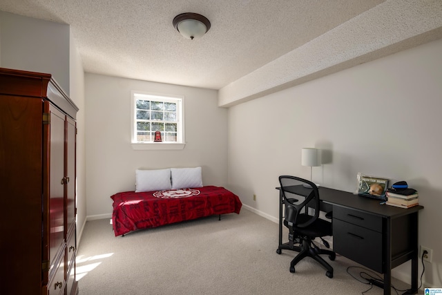 bedroom with carpet floors, baseboards, and a textured ceiling