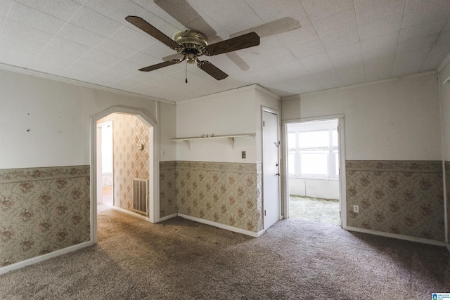 empty room with wallpapered walls, visible vents, a wainscoted wall, and carpet flooring