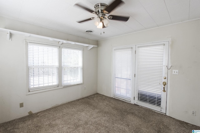 empty room featuring carpet floors and a ceiling fan