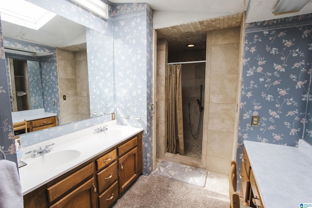 full bathroom with wallpapered walls, a skylight, a sink, and tiled shower