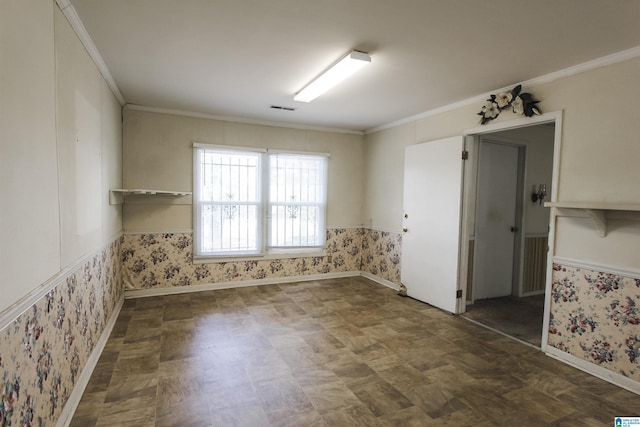 spare room with ornamental molding, visible vents, and wallpapered walls