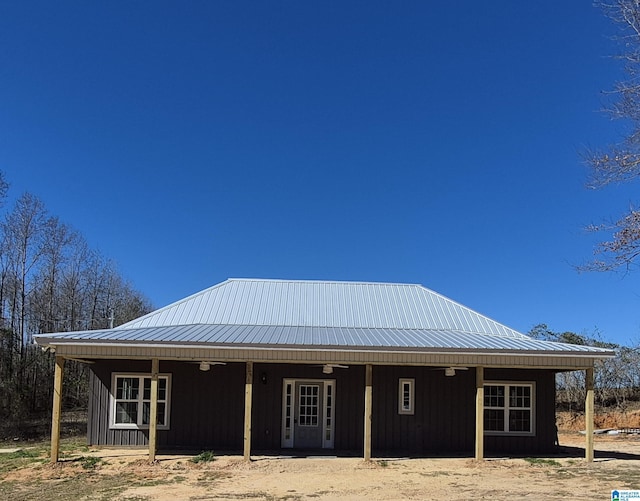 back of house featuring metal roof and board and batten siding