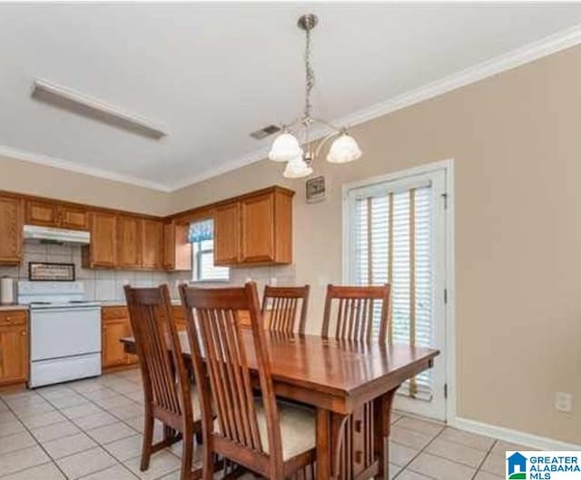 dining room with light tile patterned flooring, visible vents, baseboards, ornamental molding, and an inviting chandelier