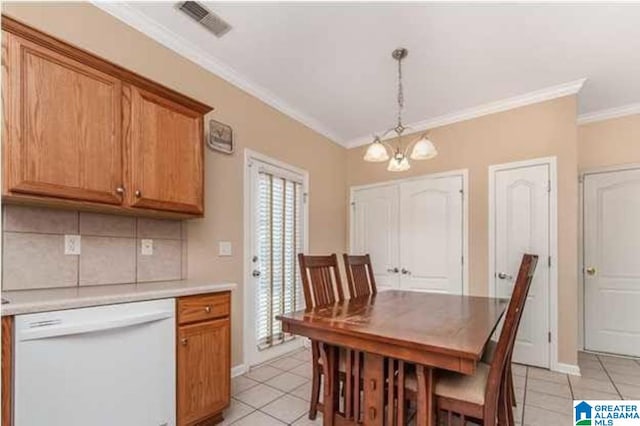 dining room featuring baseboards, visible vents, ornamental molding, a notable chandelier, and light tile patterned flooring