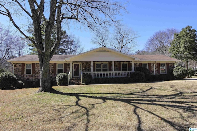 ranch-style home with a front yard, a porch, and brick siding