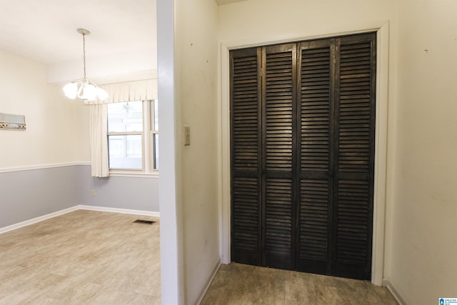 interior details featuring a notable chandelier, baseboards, visible vents, and wood finished floors