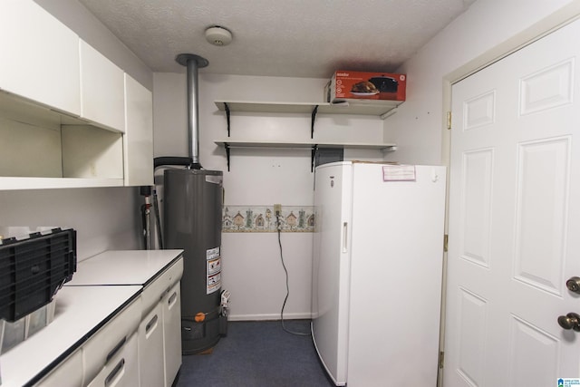 kitchen with open shelves, light countertops, water heater, freestanding refrigerator, and white cabinets